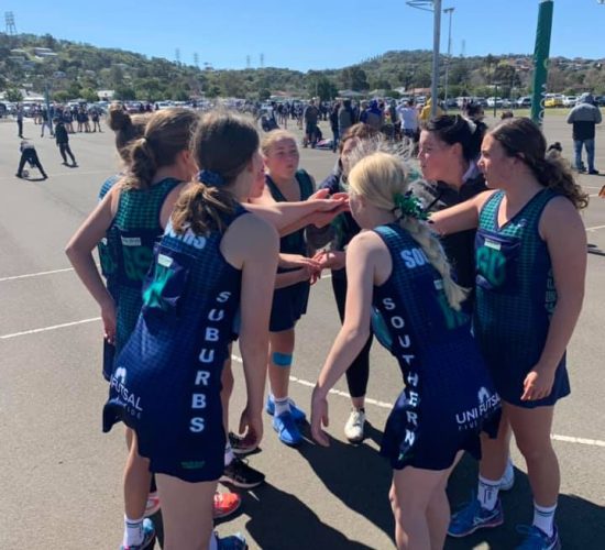 southern suburbs junior team on court with hands in before game southern suburbs junior team on court with hands in before game