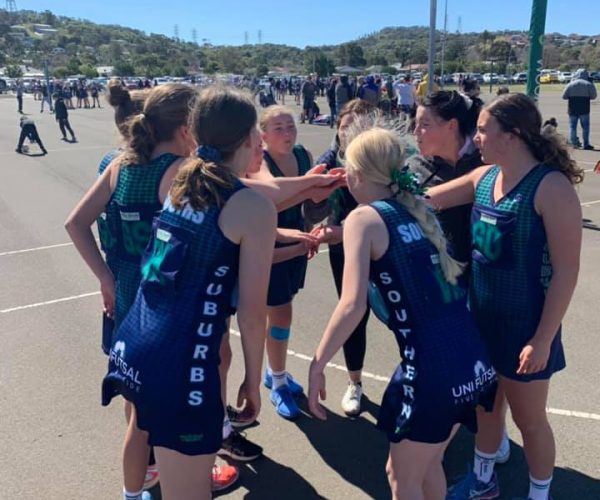 southern suburbs junior team on court with hands in before game southern suburbs junior team on court with hands in before game